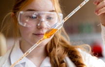 Eine junge Chemikerin mit einer Pipette 